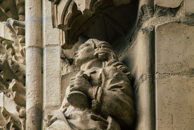 Low angle view of statue against old building