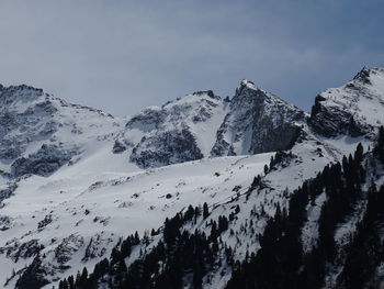 Scenic view of snow covered mountains against sky