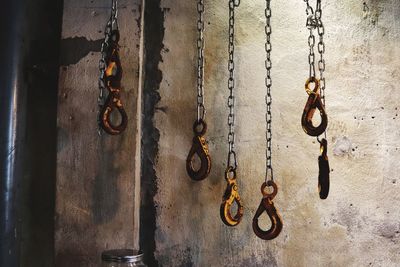 Close-up of chain hanging against wall