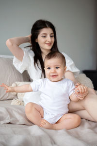 Portrait of cute baby boy sleeping on bed at home