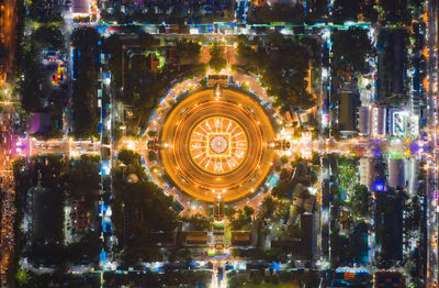 Aerial view of illuminated temple in city at night