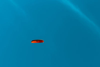 Low angle view of kite flying against blue sky