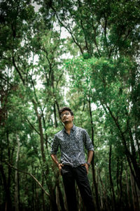 Young man standing in forest