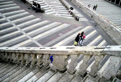 High angle view of people walking on staircase