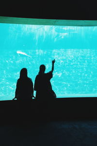 Silhouette man in swimming pool