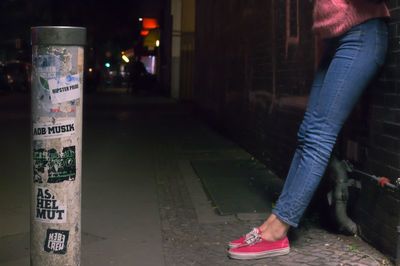 Woman in illuminated city at night