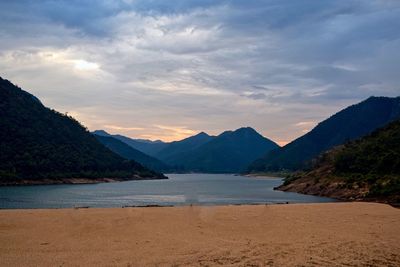 Scenic view of beach against sky during sunset