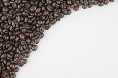 Close-up of coffee beans against white background