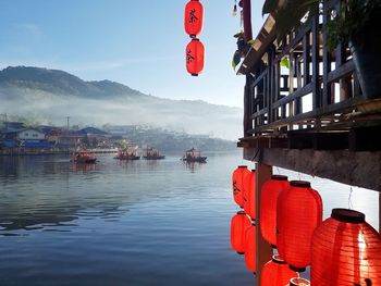 Red lanterns hanging over mountain against sky