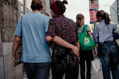 Rear view of people standing on street