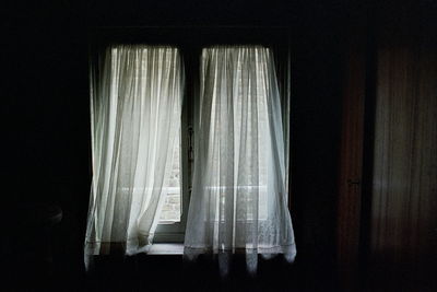 Close-up of curtain against window at home