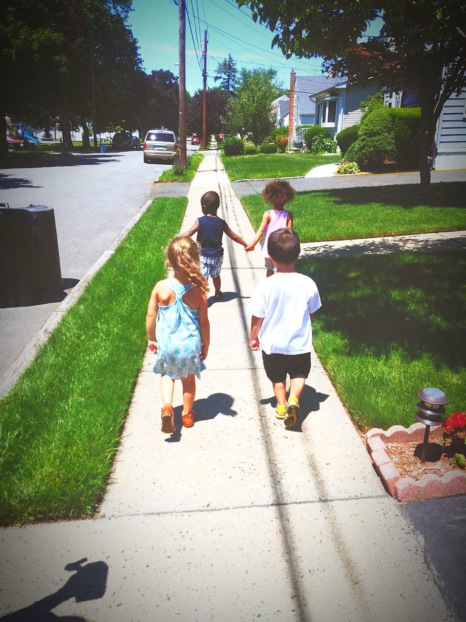 full length, lifestyles, childhood, leisure activity, tree, park - man made space, footpath, street, rear view, walking, boys, togetherness, sunlight, grass, men, casual clothing, shadow, girls