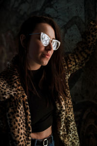 Side view of thoughtful young woman wearing eyeglasses