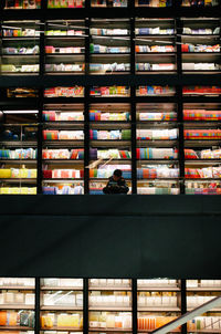 Full length of man sitting on book