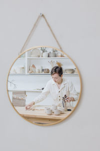 Portrait of woman standing against white background