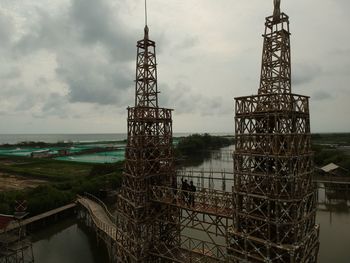 View of communications tower against cloudy sky