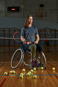 Portrait of young woman sitting on playing field