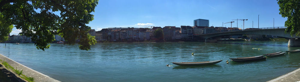 Bridge over river in city against sky