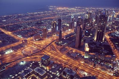 High angle view of illuminated cityscape against sky at night