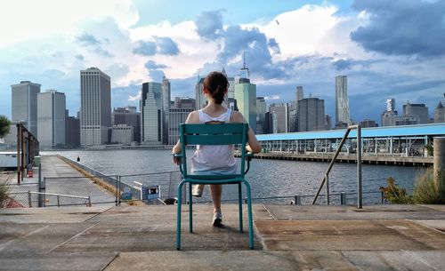 Full length of woman looking at city skyline