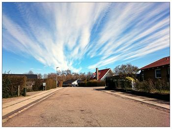 Empty road against cloudy sky