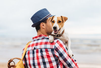 Portrait of dog wearing hat against sea