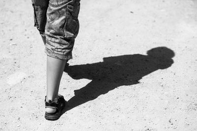 Low section of man standing on street