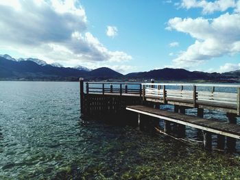 Pier over lake against sky