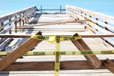 Close-up of cordon tape on wooden pier