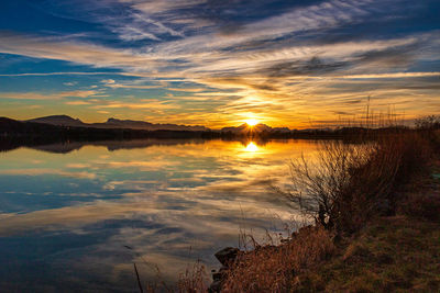 Scenic view of lake against sky during sunset