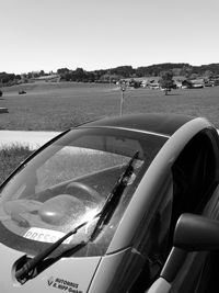 Close-up of car on landscape against clear sky