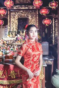 Portrait of young woman standing at night