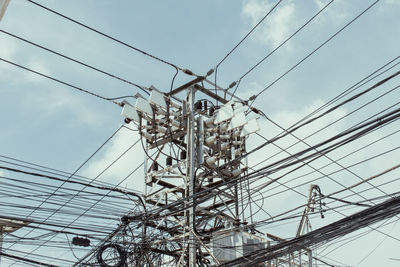 Low angle view of electricity pylon against sky