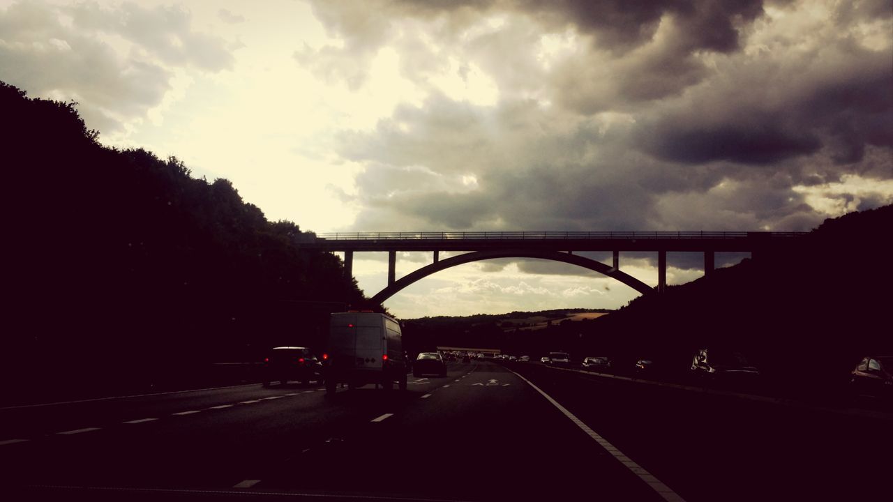 transportation, road, sky, car, land vehicle, cloud - sky, mode of transport, connection, bridge - man made structure, cloudy, road marking, the way forward, street, highway, cloud, built structure, on the move, weather, diminishing perspective, architecture