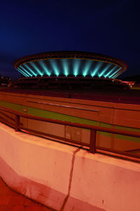 Low angle view of illuminated building against sky at night