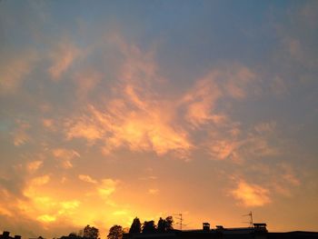 Low angle view of built structure against sunset sky