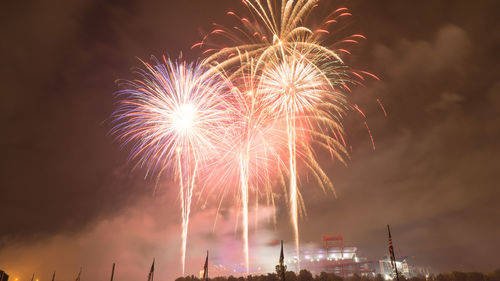 Low angle view of firework display at night