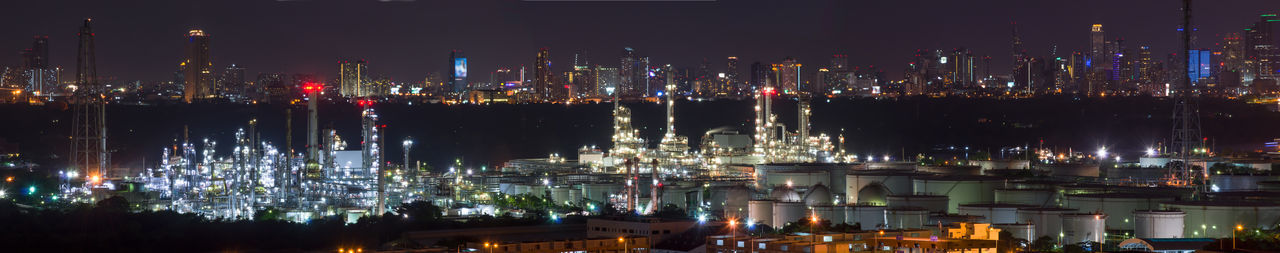 High angle view of illuminated buildings by river at night