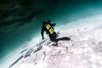 Rear view of scuba diver under water