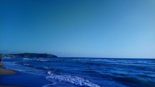 Scenic view of sea against clear blue sky