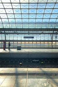 View of railroad station platform seen through window