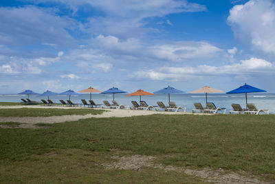 Public beach of flic en flac with beach umbrellas during the summer in the west coast  of mauritius.