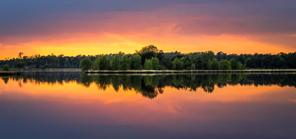 Scenic view of calm lake at sunset