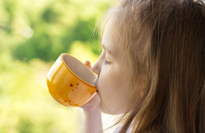 Close-up portrait of a woman drinking glass