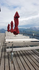 Red umbrella on a mountain against sky