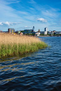 Scenic view of sea and buildings against sky