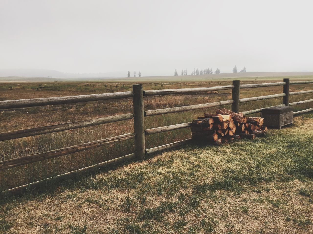 clear sky, field, fence, landscape, tranquil scene, tranquility, copy space, nature, scenics, grass, sky, beauty in nature, railing, protection, day, outdoors, safety, no people, metal, non-urban scene