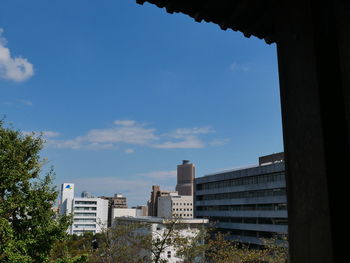 Low angle view of buildings against blue sky