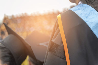 Women wearing mortarboard against sky