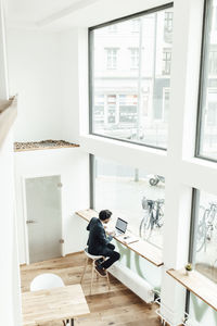 Man sitting on chair by table at home
